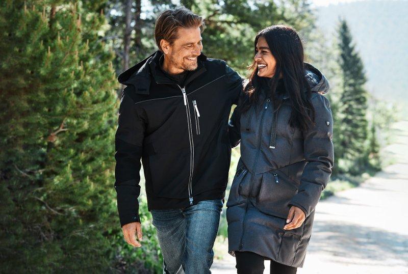 Man and Woman wearing Ariat Outerwear in the snow